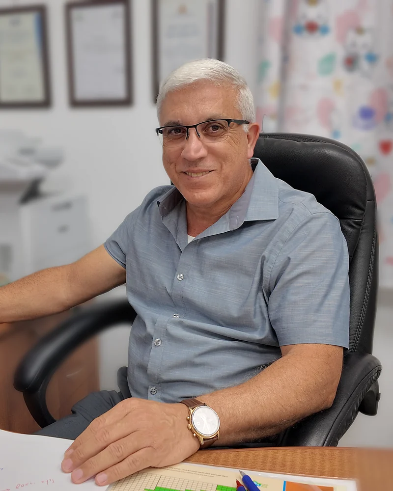 Dr. Qassem Kaiyal at his desk in the clinic